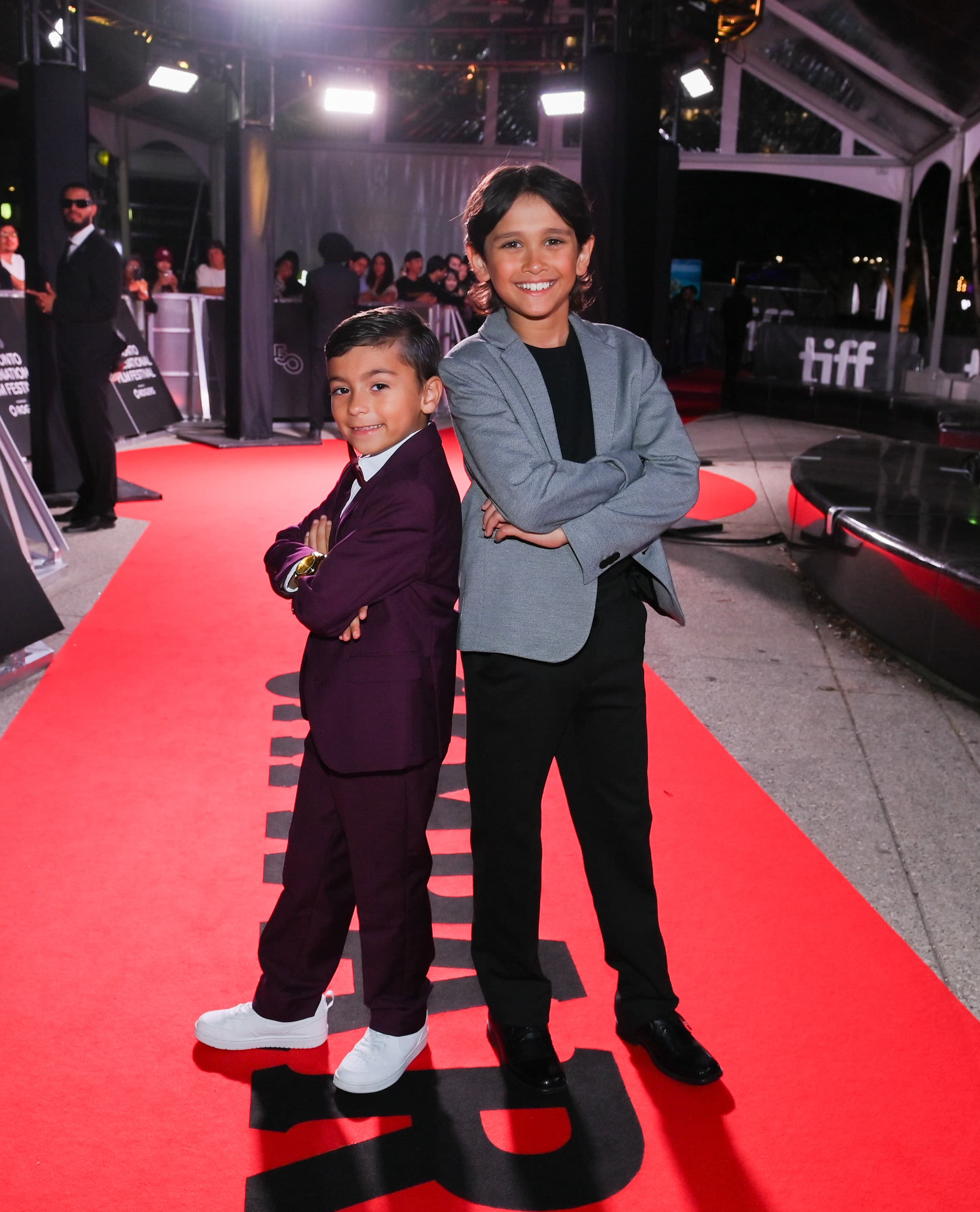 Two young actors posing together on the TIFF red carpet