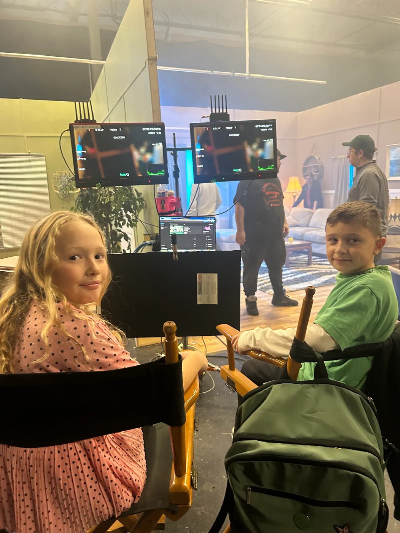 Victoria and a fellow young performer in director’s chairs on set